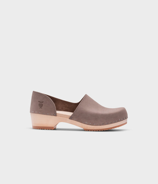 low heeled closed-back clogs in stone grey nubuck leather stapled on a light wooden base