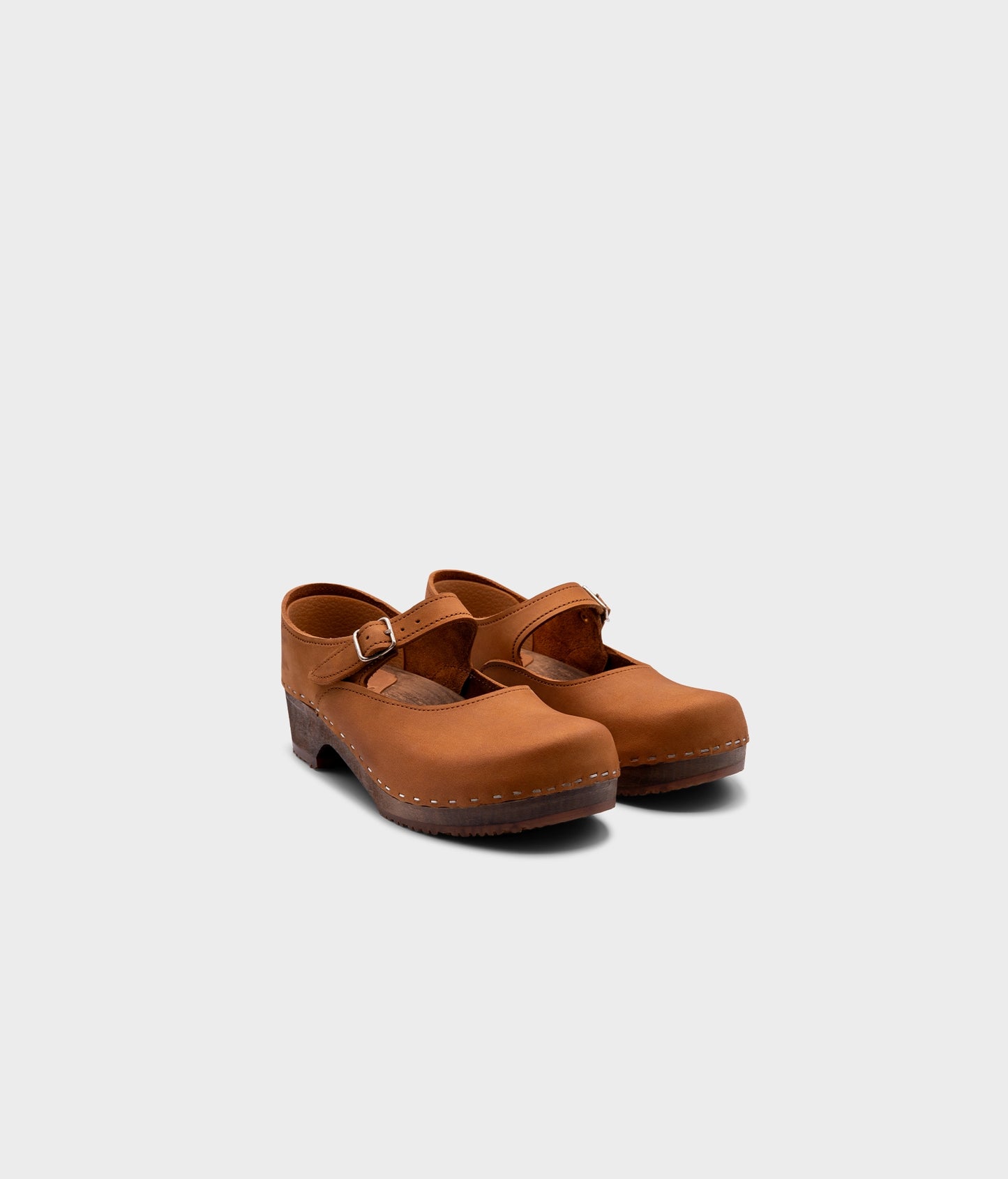 Mary Jane wooden clogs in light brown nubuck leather stapled on a dark wooden base