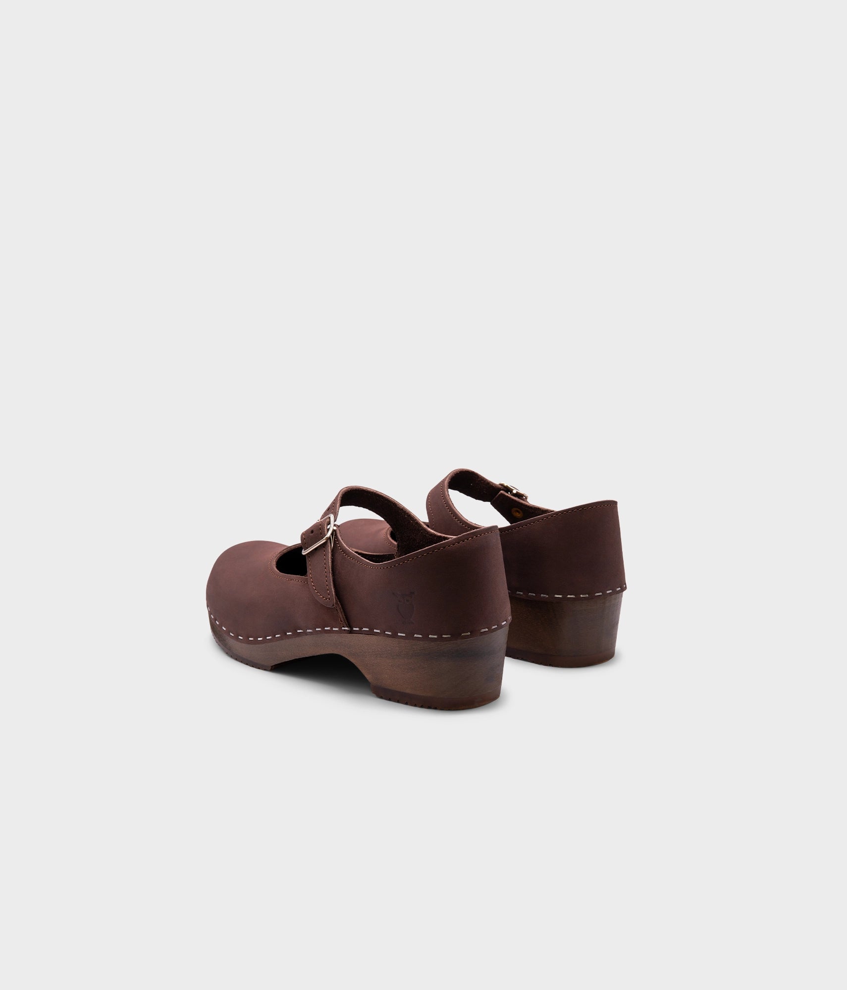 Mary Jane wooden clogs in dark brown nubuck leather stapled on a dark wooden base