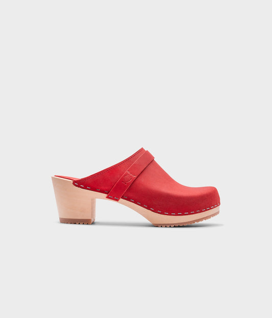 classic high heeled clog mule in red nubuck leather stapled on a light wooden base with a leather strap