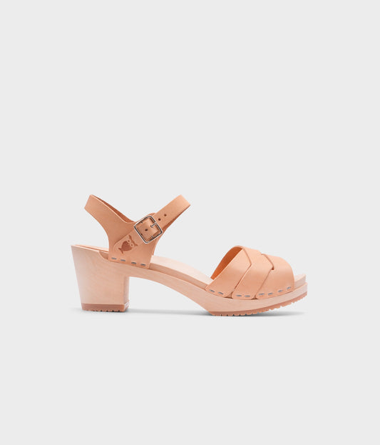 high heeled clog sandals in ecru beige vegetable tanned leather with an open-toe stapled on a light wooden base