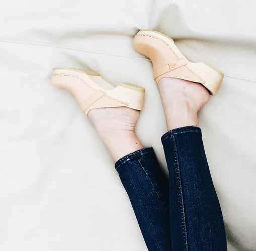 clog mules on a light wood base with nude beige leather upper