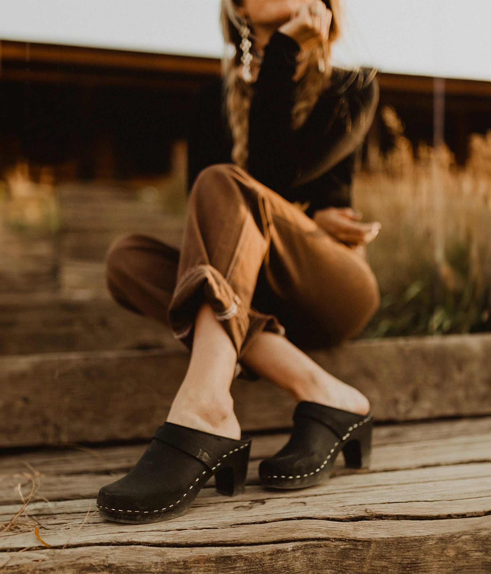 classic high rise heel clog mule in black nubuck leather stapled on a black wooden base