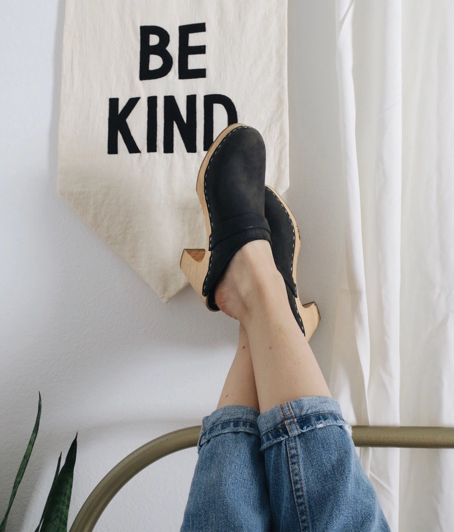 classic high rise heel clog mule in black nubuck leather stapled on a light wooden base