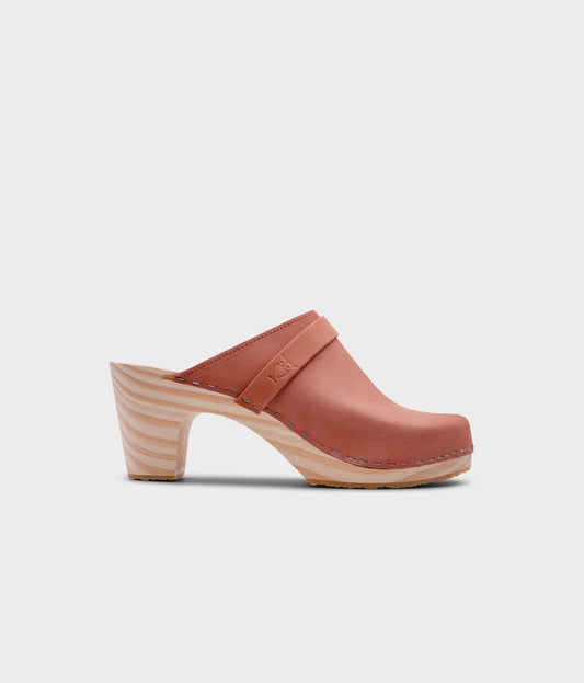 classic high rise heel clog mule in blush pink nubuck leather stapled on a light wooden base