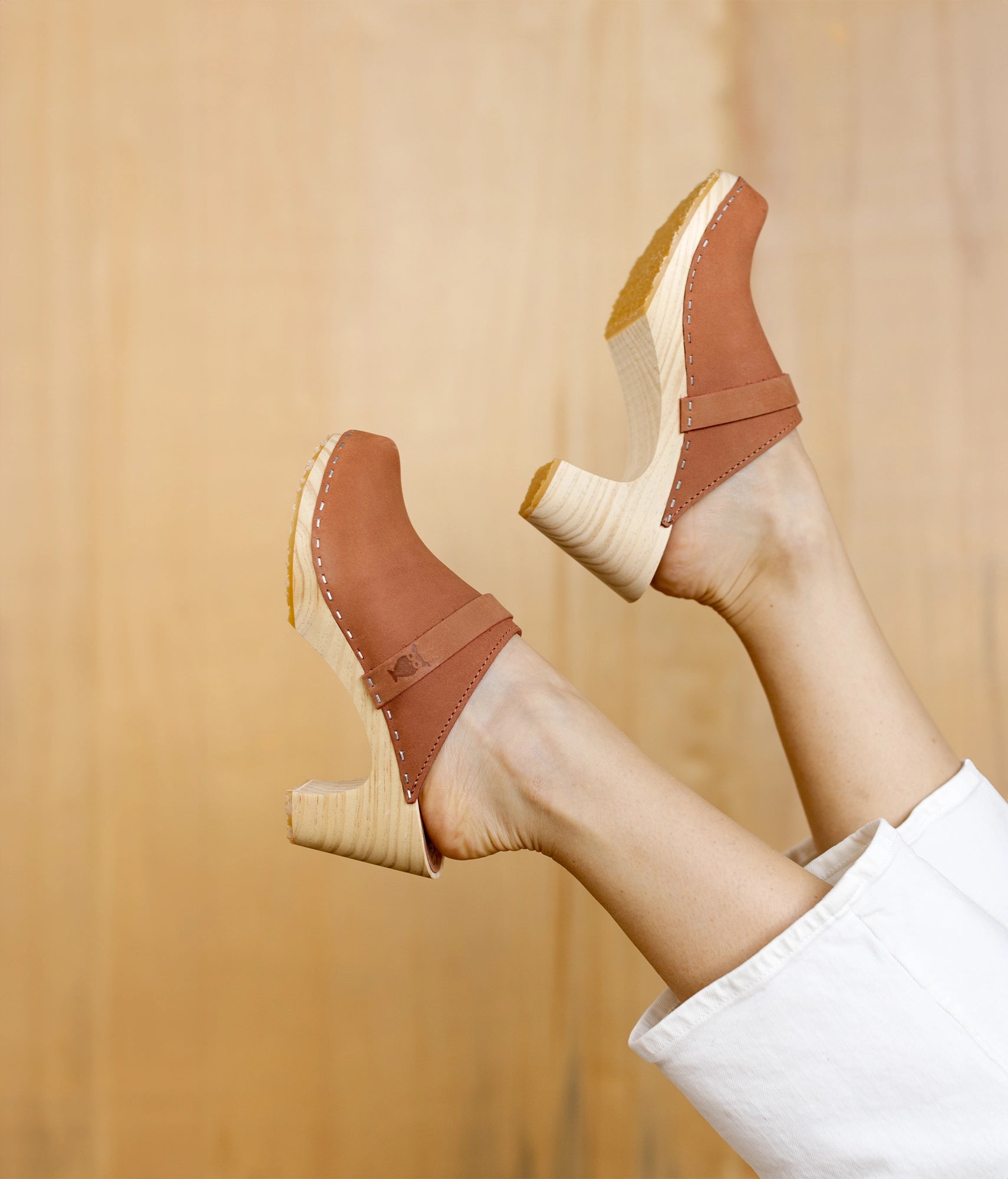 classic high rise heel clog mule in blush pink nubuck leather stapled on a light wooden base