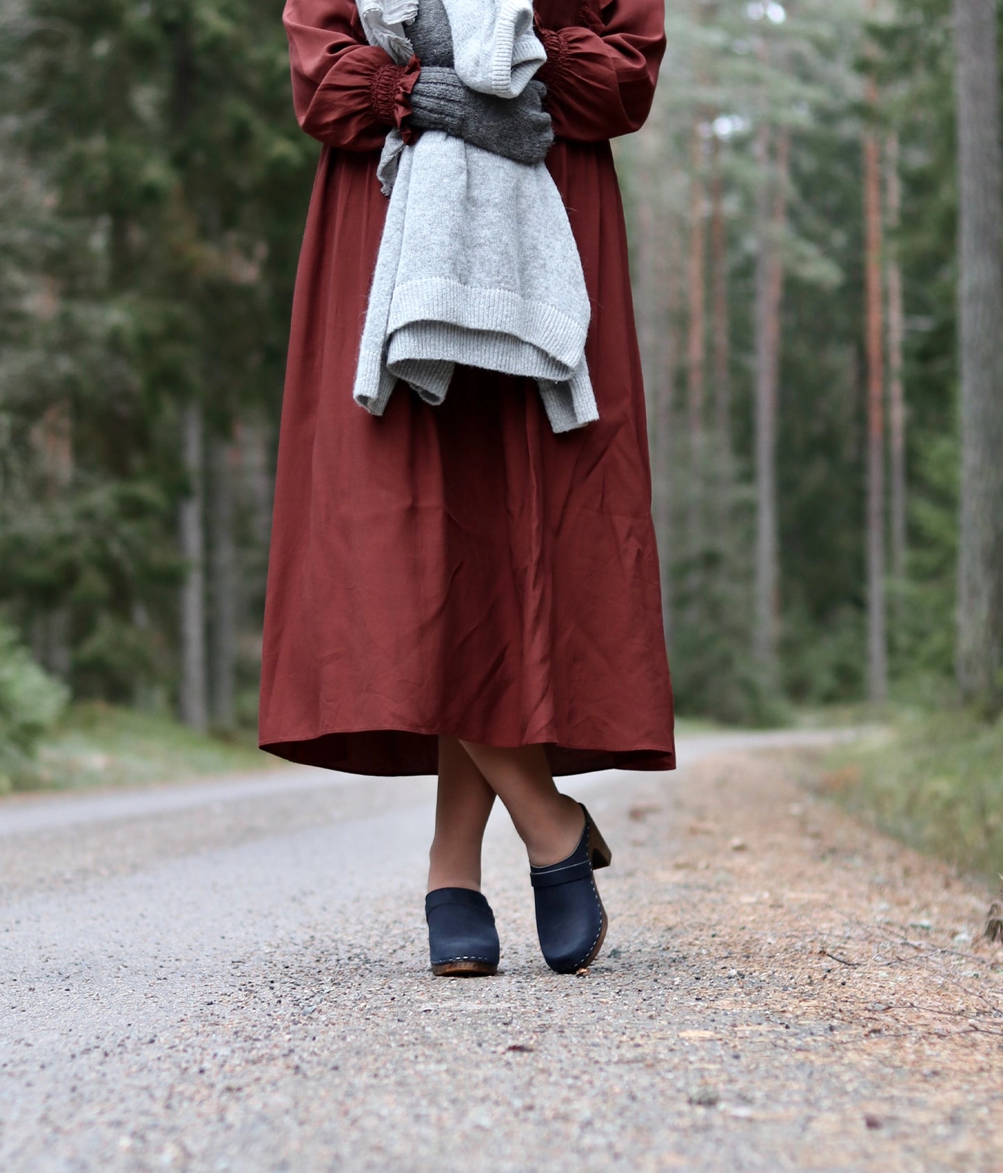 classic high rise heel clog mule in navy blue nubuck leather stapled on a dark wooden base