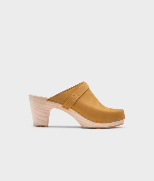 classic high rise heel clog mule in yellow nubuck leather stapled on a light wooden base