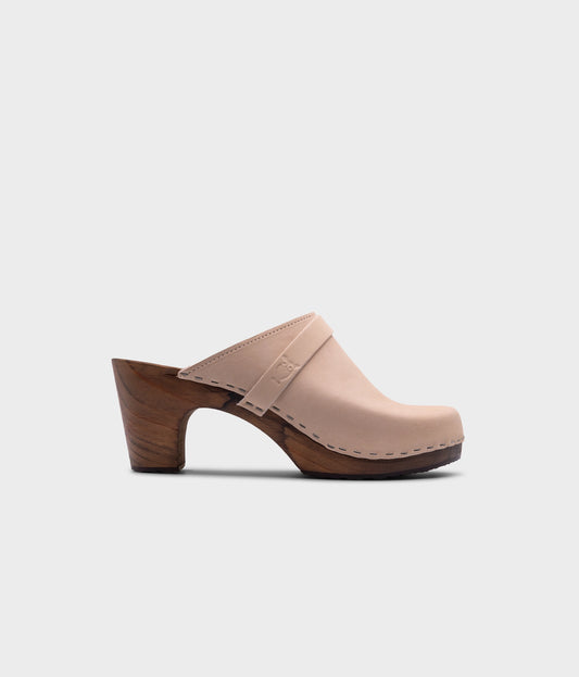 classic high rise heel clog mule in white sand nubuck leather stapled on a dark wooden base