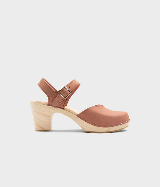 High rise heel classic clog sandals in blush pink nubuck leather stapled on a light wooden base