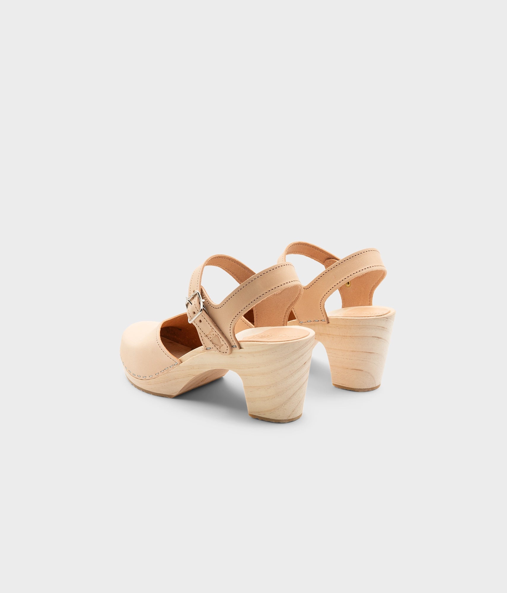 High rise heel classic clog sandals in ecru beige vegetable tanned leather stapled on a light wooden base