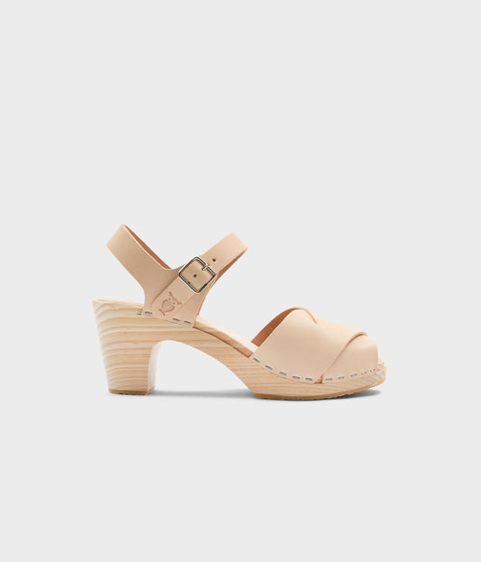 high rise heel crossed clog sandals in ecru beige vegetable tanned leather stapled on a light wooden base