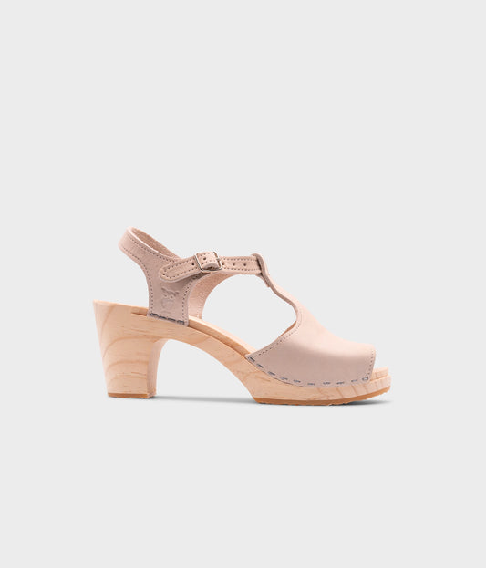 high rise heeled open toe clog sandal in sand white nubuck leather stapled on a light wooden base
