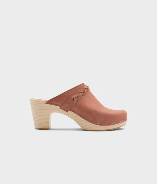 high rise heel braided clog mule in blush pink leather stapled on a light wooden base
