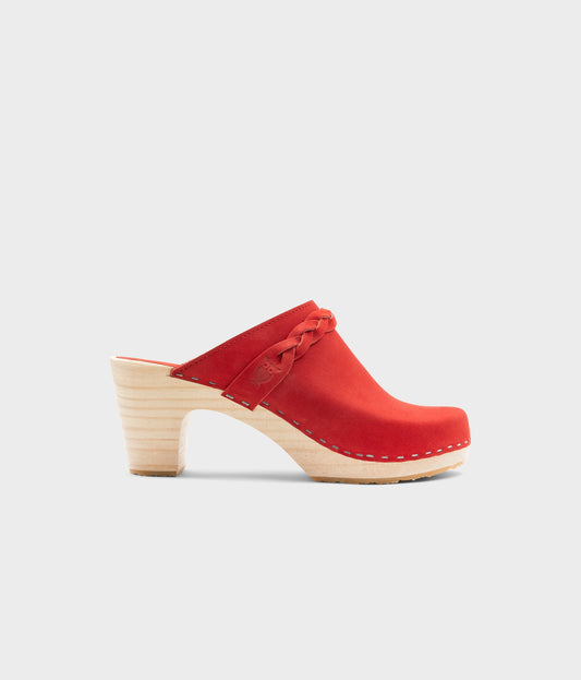 high rise heel braided clog mule in red leather stapled on a light wooden base