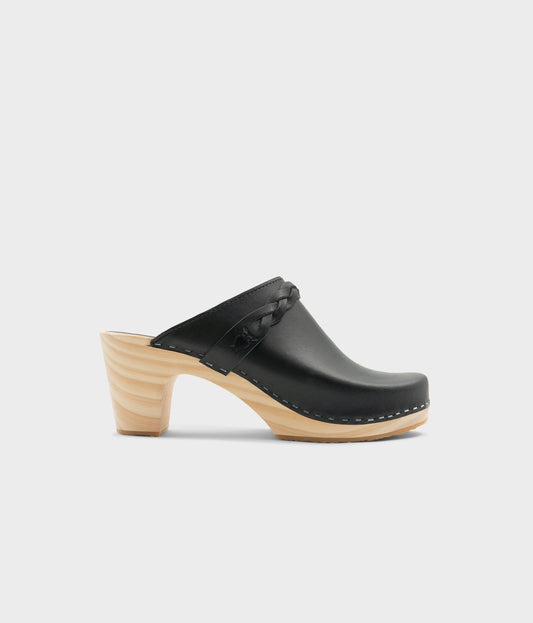 high rise heel braided clog mule in black vegetable tanned leather stapled on a light wooden base