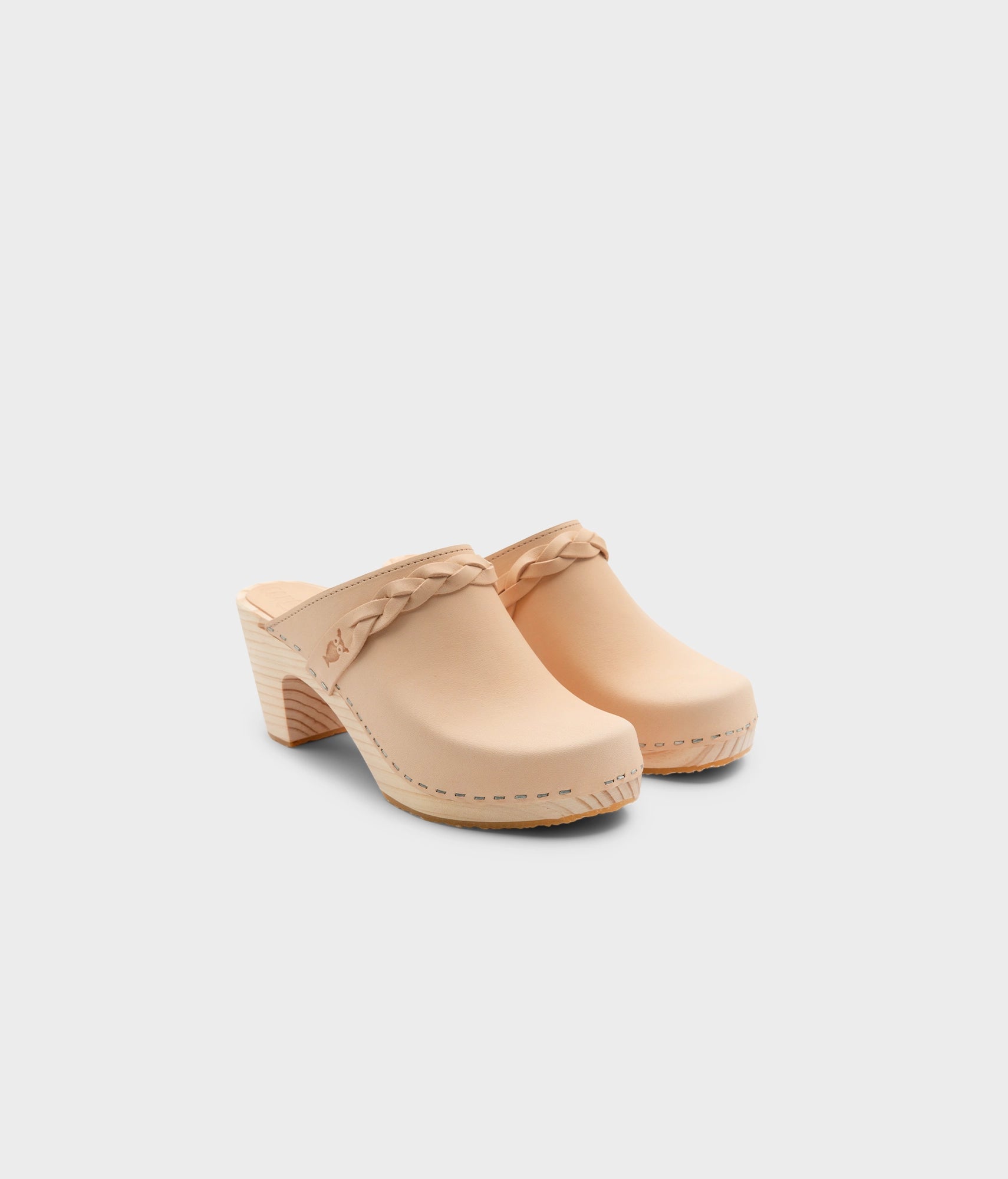 high rise heel braided clog mule in ecru beige vegetable tanned leather stapled on a light wooden base