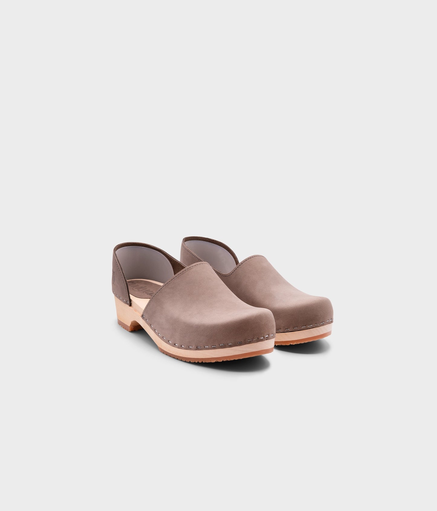 low heeled closed-back clogs in stone grey nubuck leather stapled on a light wooden base