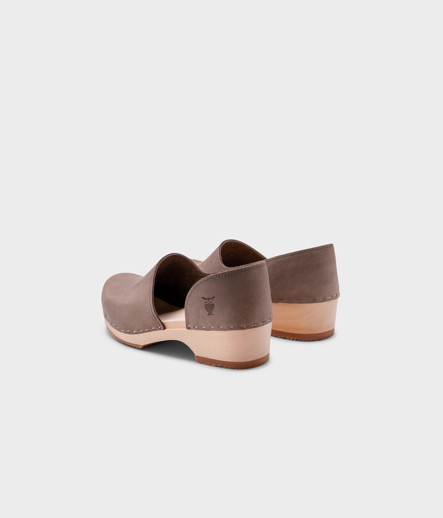 low heeled closed-back clogs in stone grey nubuck leather stapled on a light wooden base