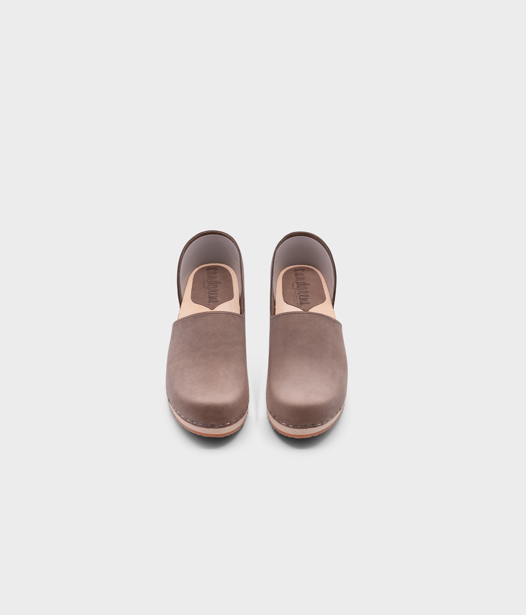 low heeled closed-back clogs in stone grey nubuck leather stapled on a light wooden base