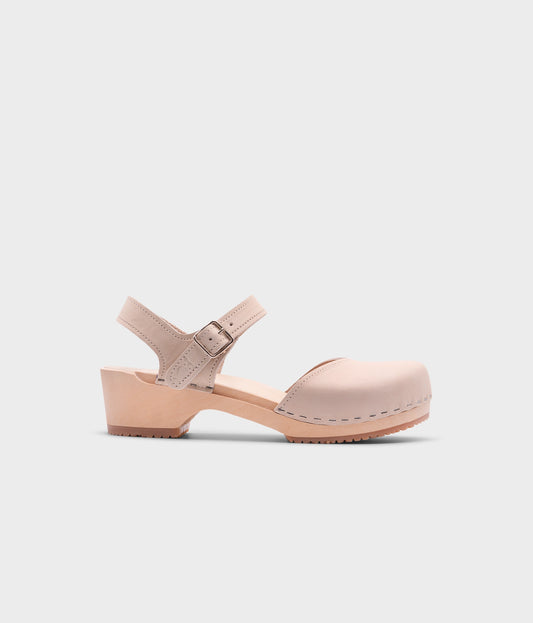 classic low heeled closed-toe sandal in sand white nubuck leather stapled on a light wooden base
