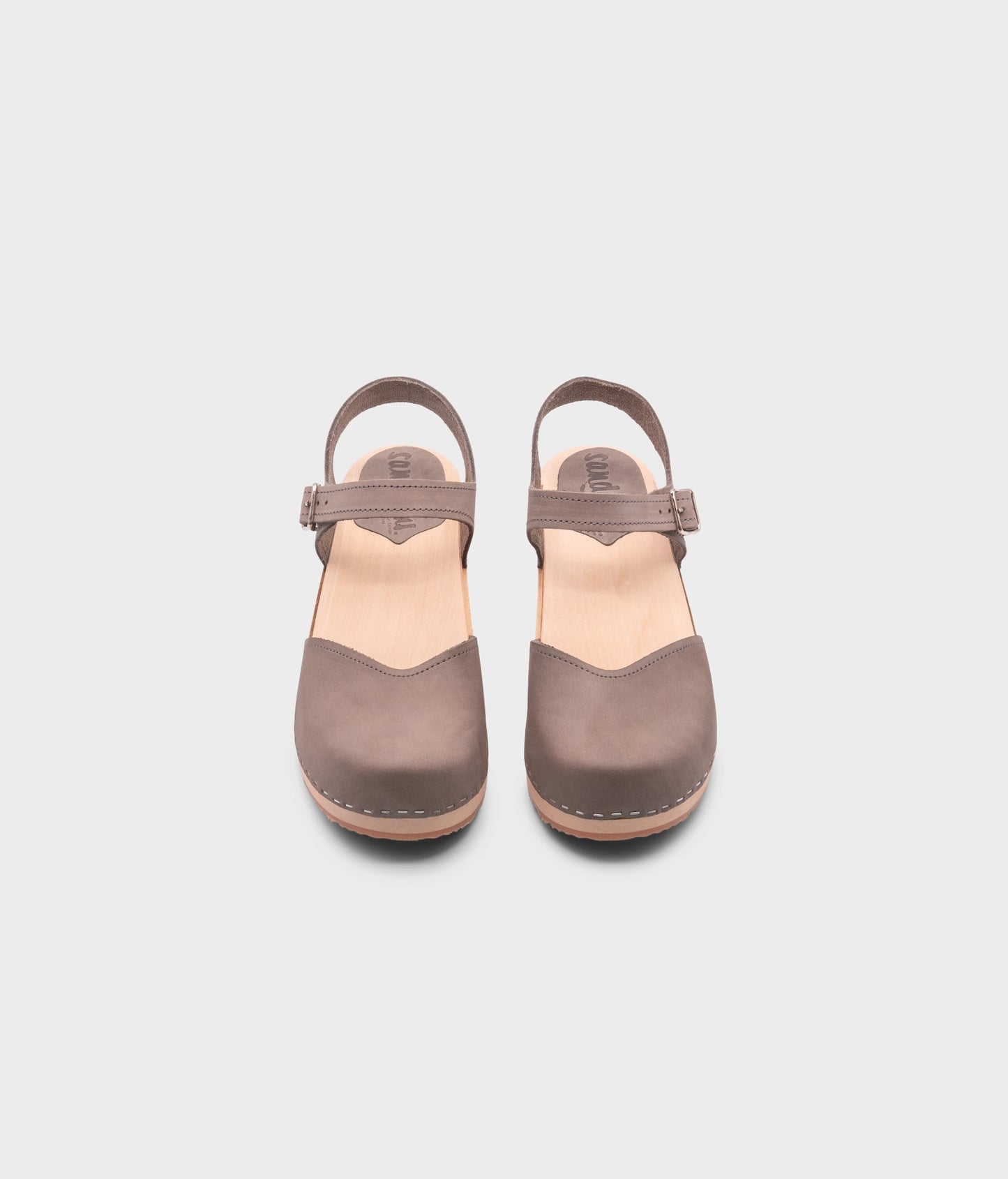 classic low heeled closed-toe sandal in stone grey nubuck leather stapled on a light wooden base