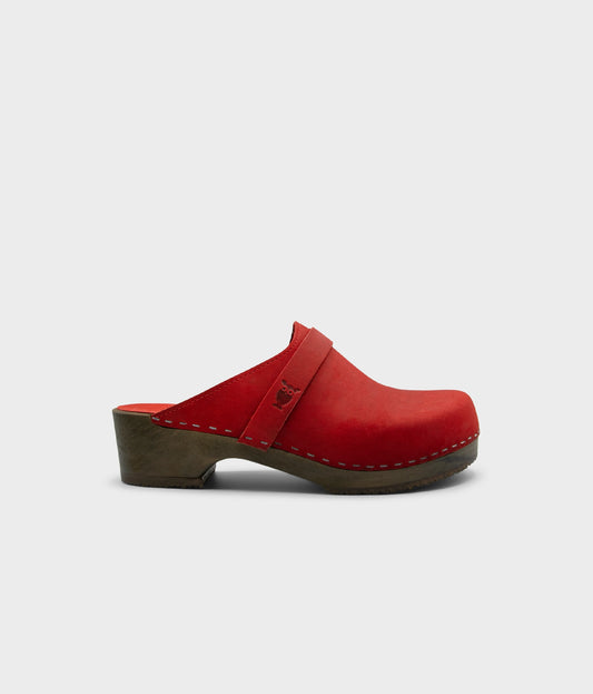 low heeled classic clog mule in red nubuck leather stapled on a dark wooden base