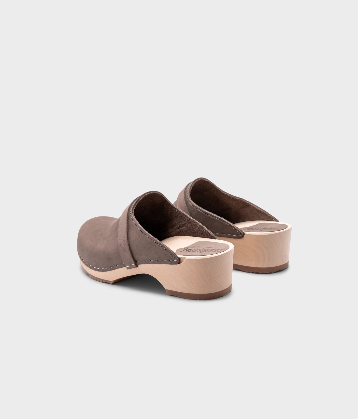 classic low heeled clog mule in stone grey nubuck leather stapled on a light wooden base with a leather strap