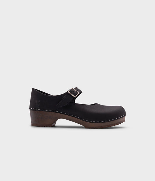 Mary Jane wooden clogs in black nubuck leather stapled on a dark wooden base