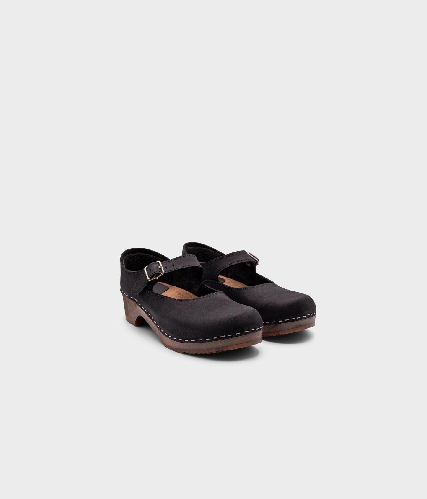 Mary Jane wooden clogs in black nubuck leather stapled on a dark wooden base