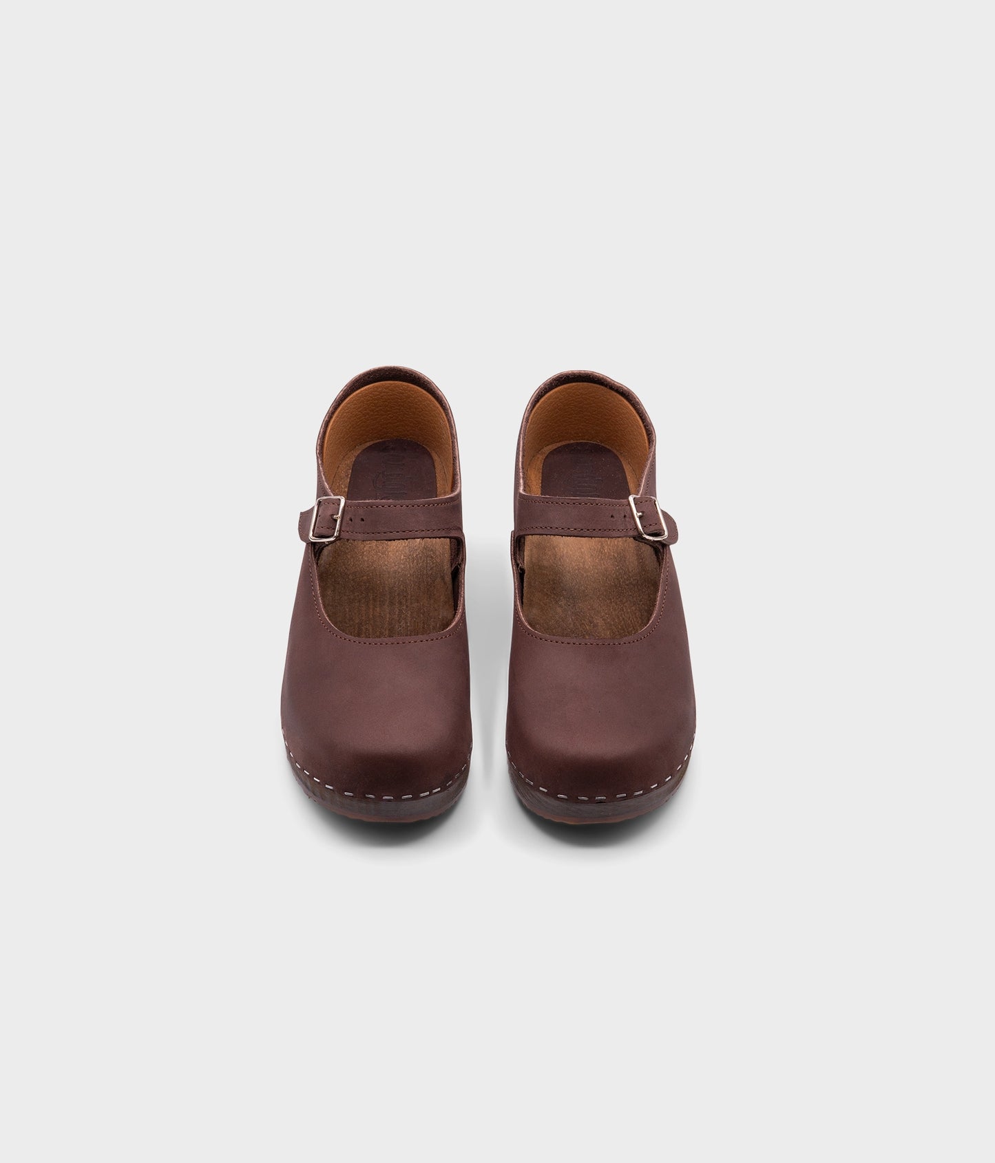 Mary Jane wooden clogs in dark brown nubuck leather stapled on a dark wooden base