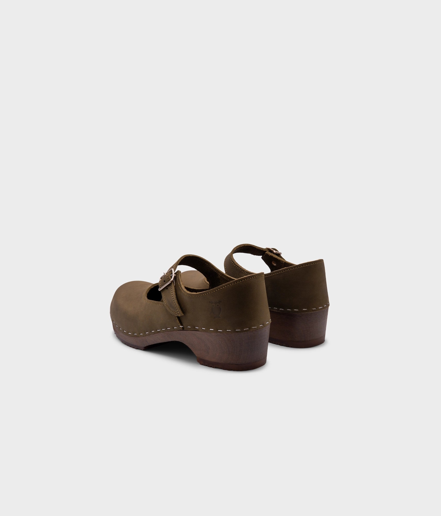 Mary Jane wooden clogs in olive green nubuck leather stapled on a dark wooden base