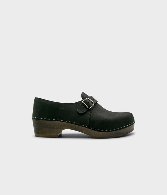 men's closed-back clogs in black nubuck leather stapled on a dark wooden base with a silver buckle