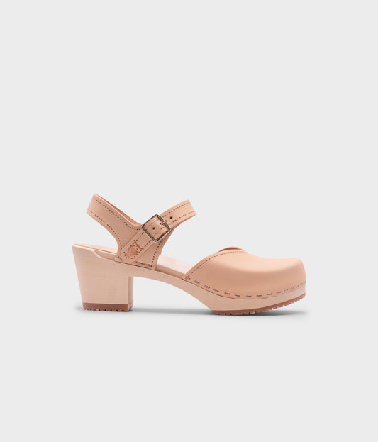 high heeled closed-toe clog sandal in ecru beige vegetable tanned leather stapled on a light wooden base