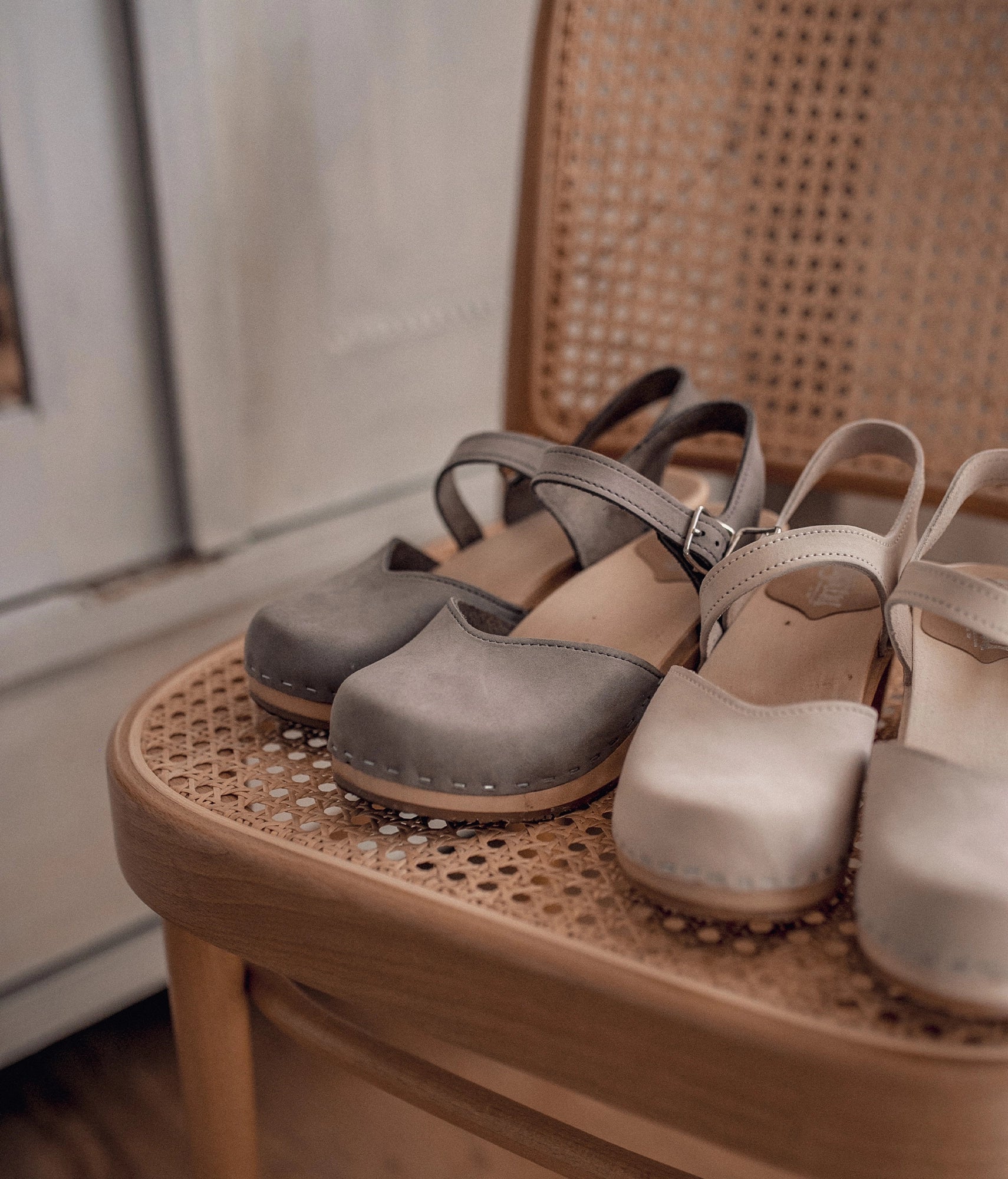 high heeled closed-toe clog sandal in stone grey nubuck leather stapled on a light wooden base