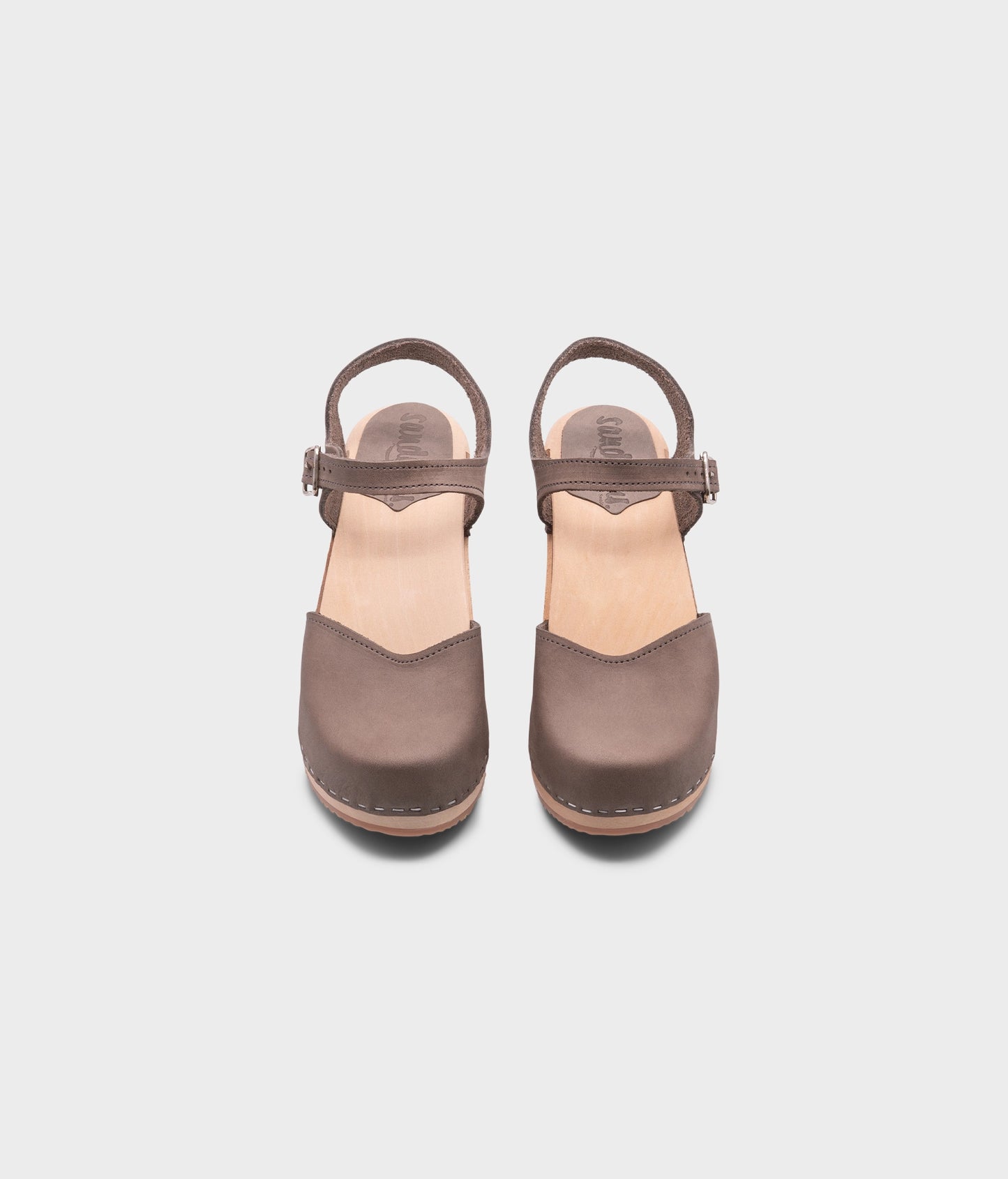 high heeled closed-toe clog sandal in stone grey nubuck leather stapled on a light wooden base