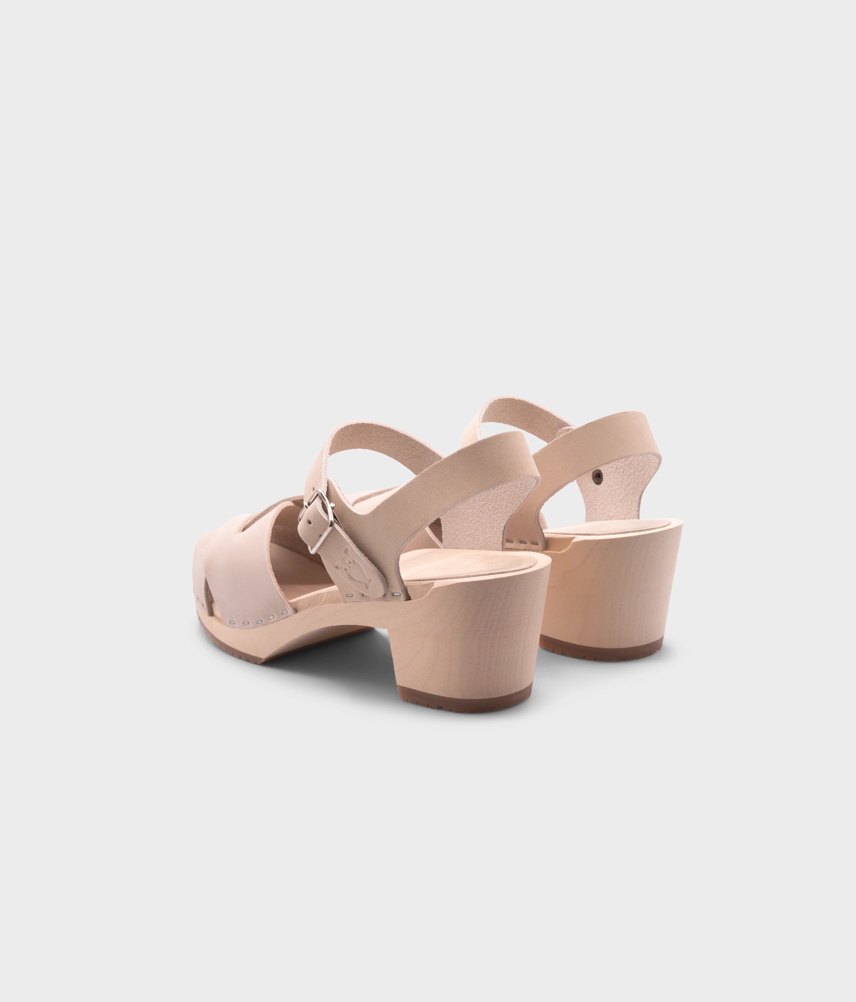 high heeled clog sandals in sand white nubuck leather with an open-toe stapled on a light wooden base