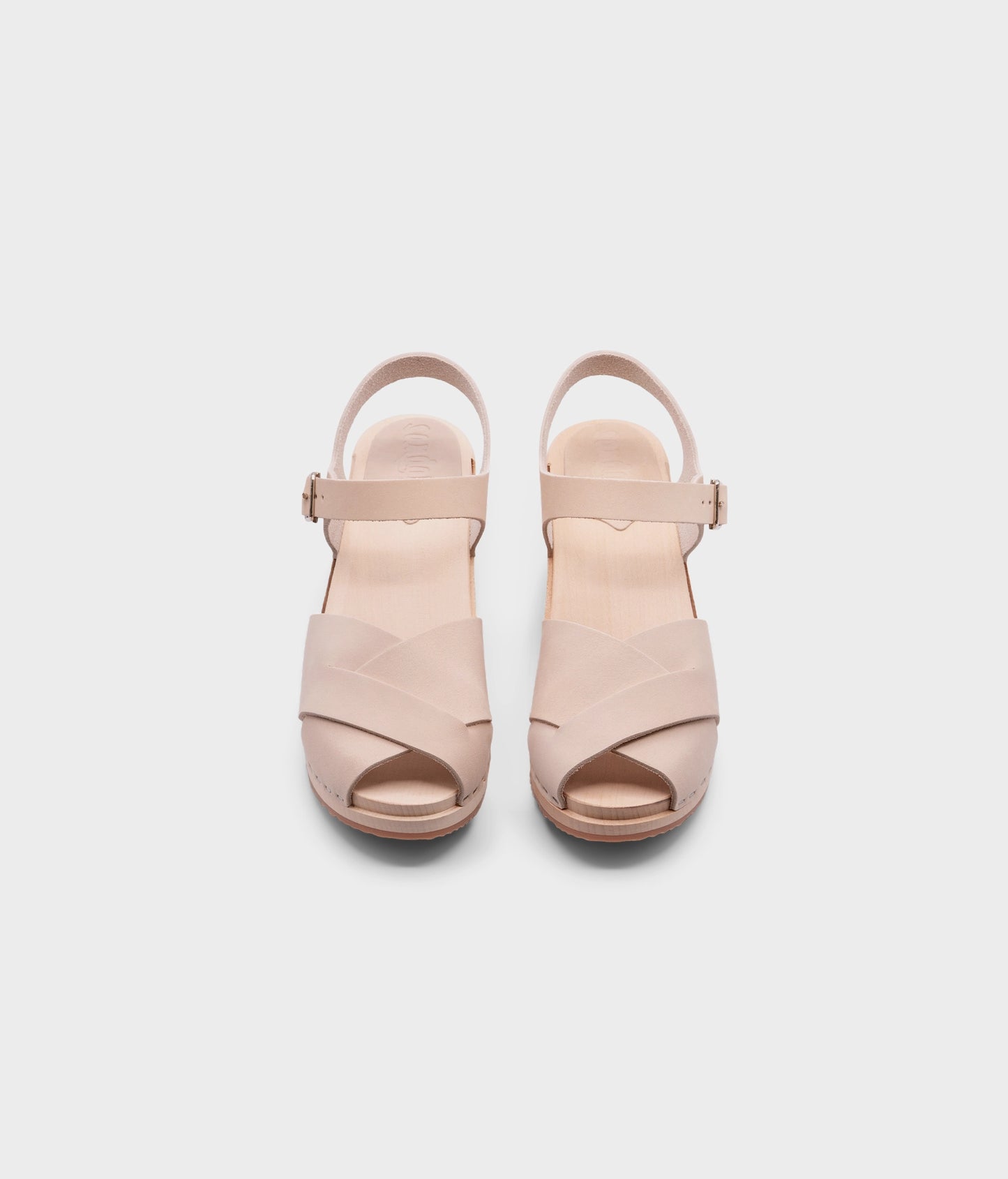 high heeled clog sandals in sand white nubuck leather with an open-toe stapled on a light wooden base