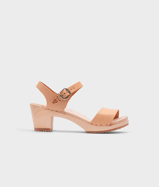 high-heeled open-toe clog sandal in ecru beige vegetable tanned leather stapled on a light wooden base