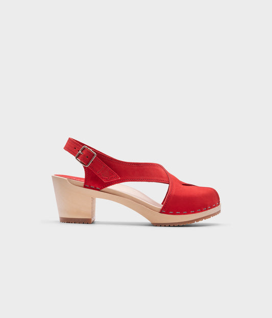 high heeled criss cross clog sandals in red nubuck leather stapled on a light wooden base