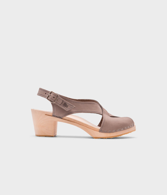 high heeled criss cross clog sandals in stone grey nubuck leather stapled on a light wooden base
