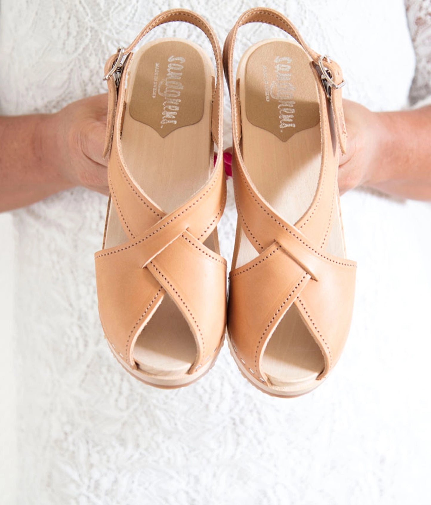 high heeled criss cross clog sandals in ecru beige vegetable tanned leather stapled on a light wooden base