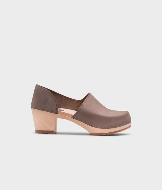 high heeled closed-back clogs in stone grey nubuck leather stapled on a light wooden base