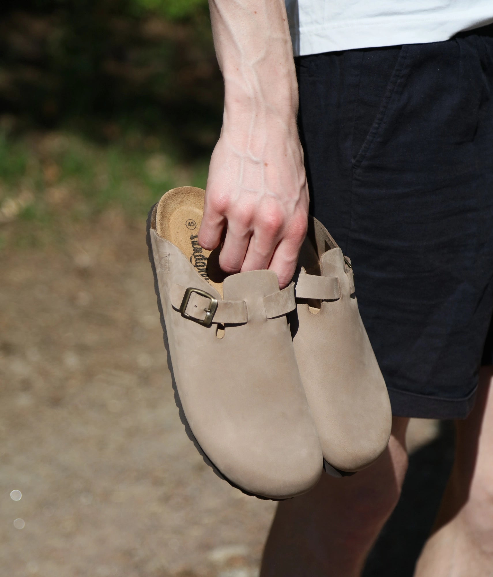 closed-toe cork sandal in standstone beige nubuck leather with a strap with a brass gold buckle, suede footbed and brown EVA outersole