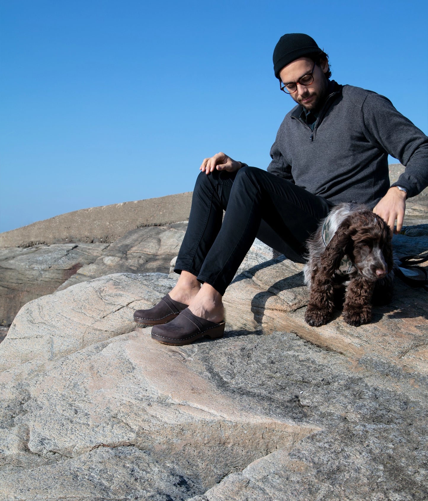 low heeled classic clog mules in dark brown nubuck leather stapled on a dark wooden base