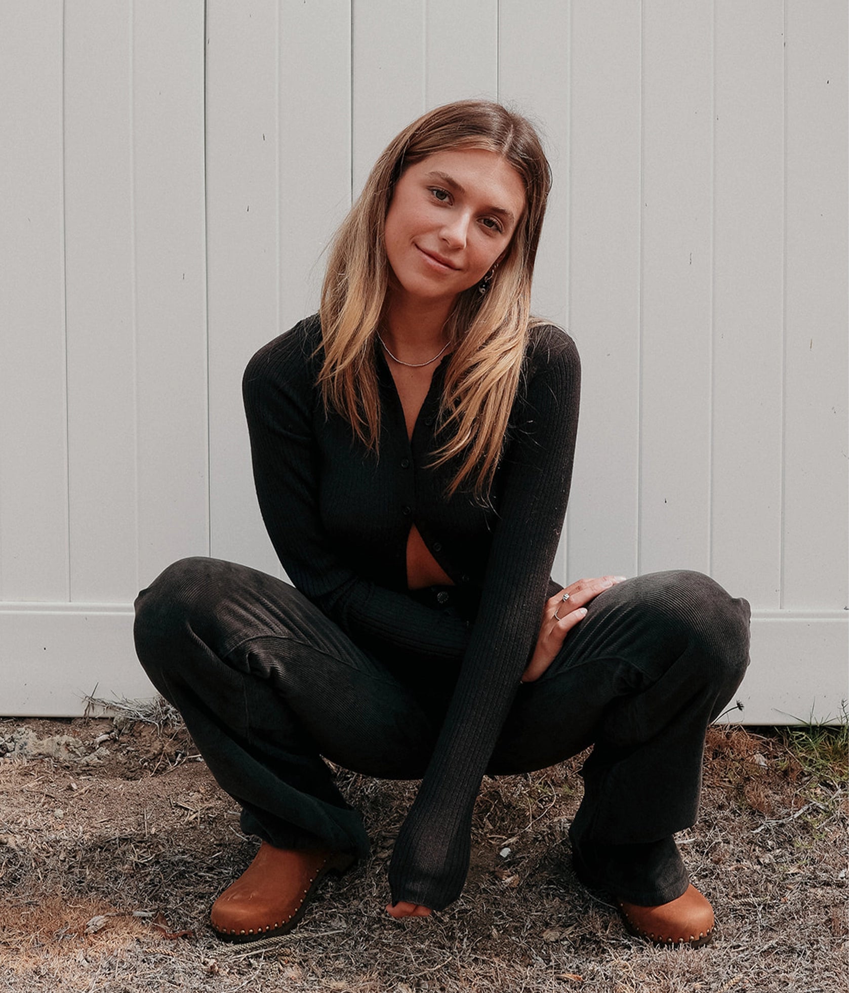 low heeled clog mules in dexter tan nubuck leather stapled on a dark wooden base with brass gold studs