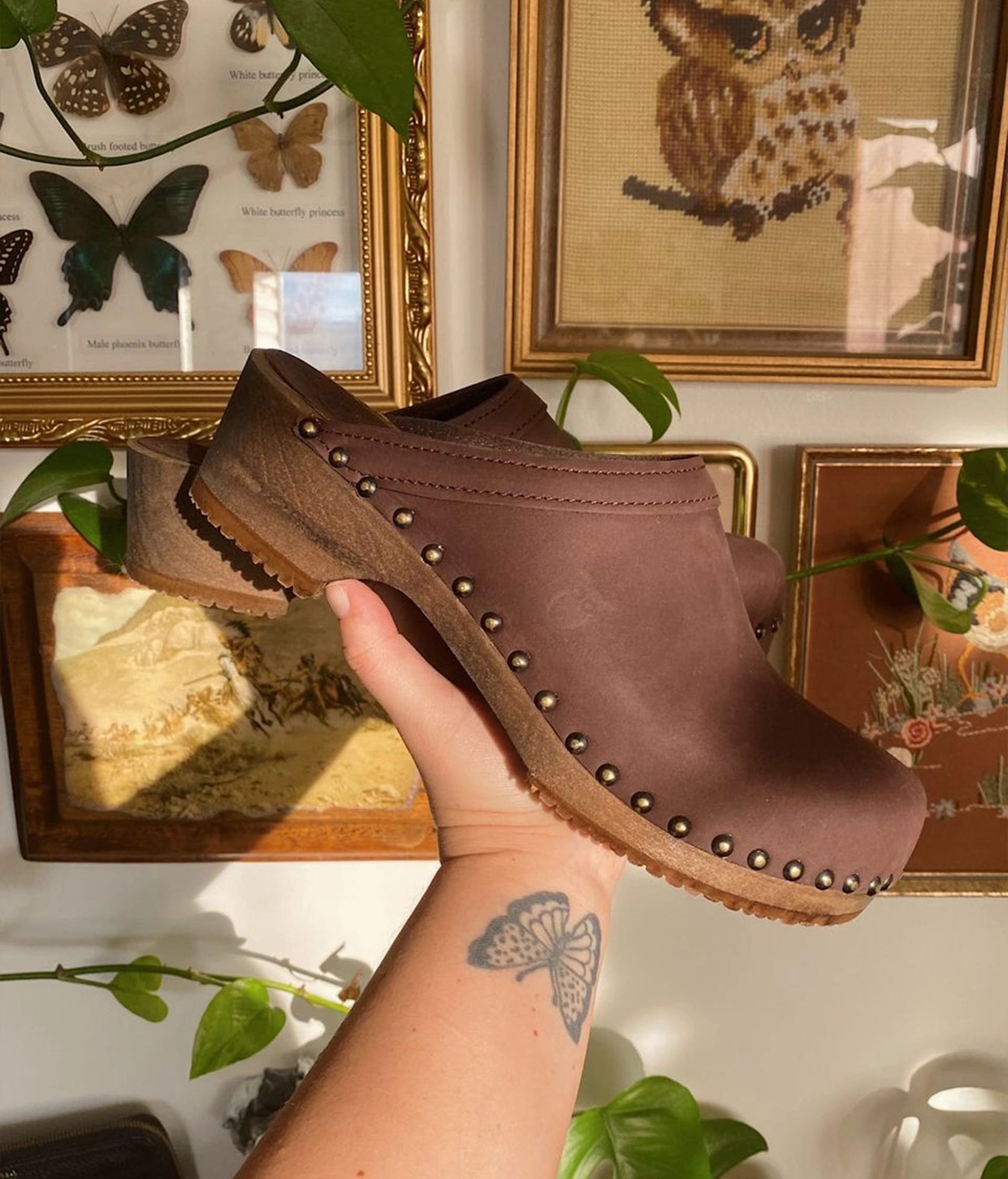 low heeled clog mules in fudge nubuck leather stapled on a dark wooden base with brass gold studs