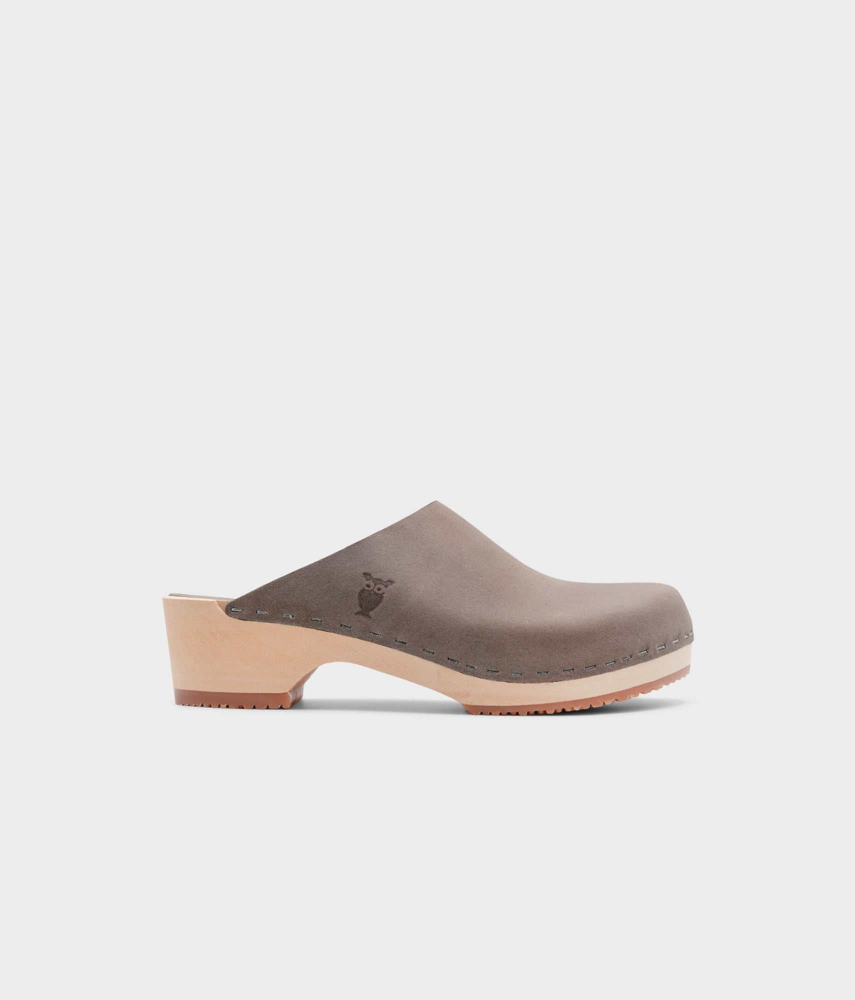 low heeled minimalistic clog mules in stone grey nubuck leather stapled on a light wooden base