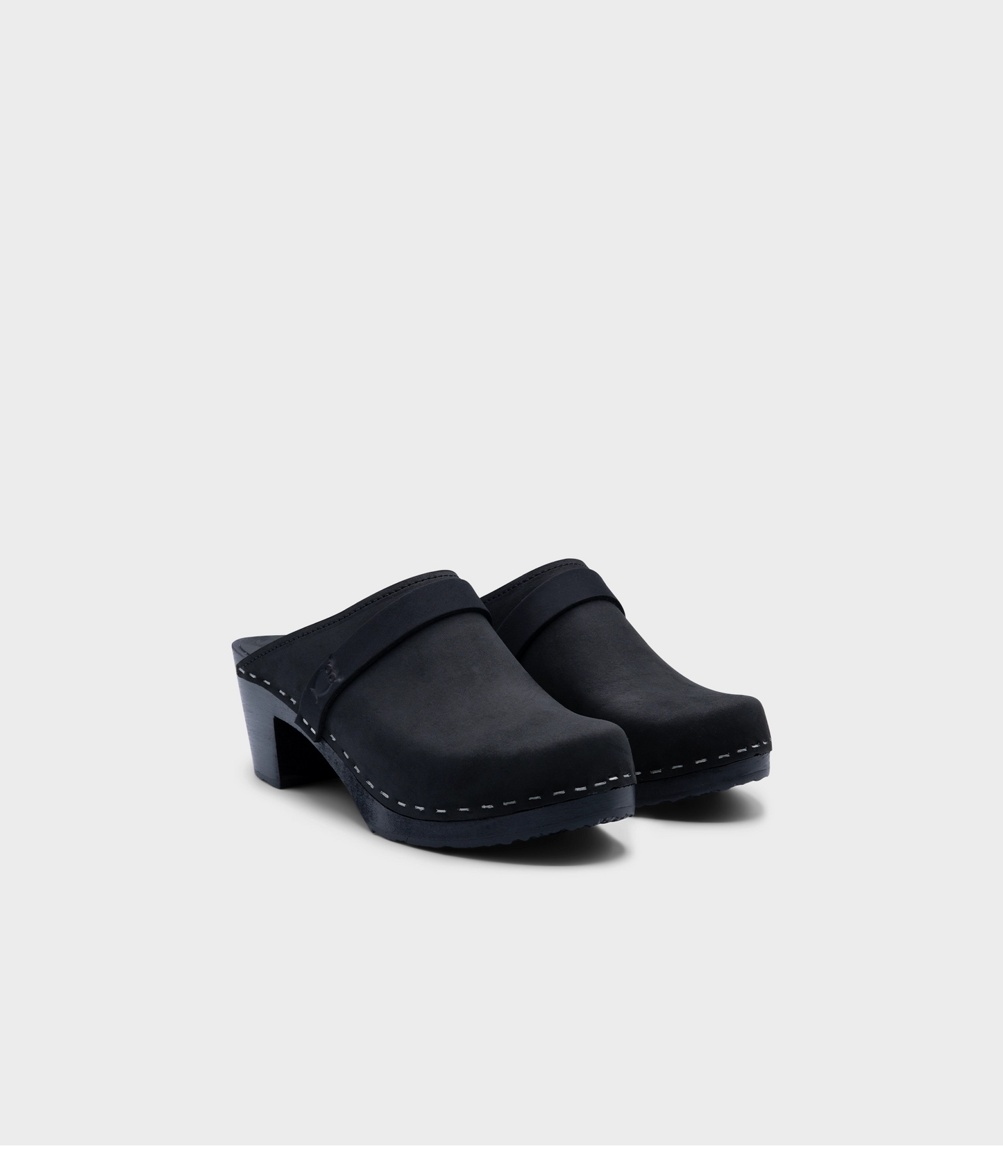 classic high heeled clog mule in black  nubuck leather stapled on a black wooden base with a leather strap
