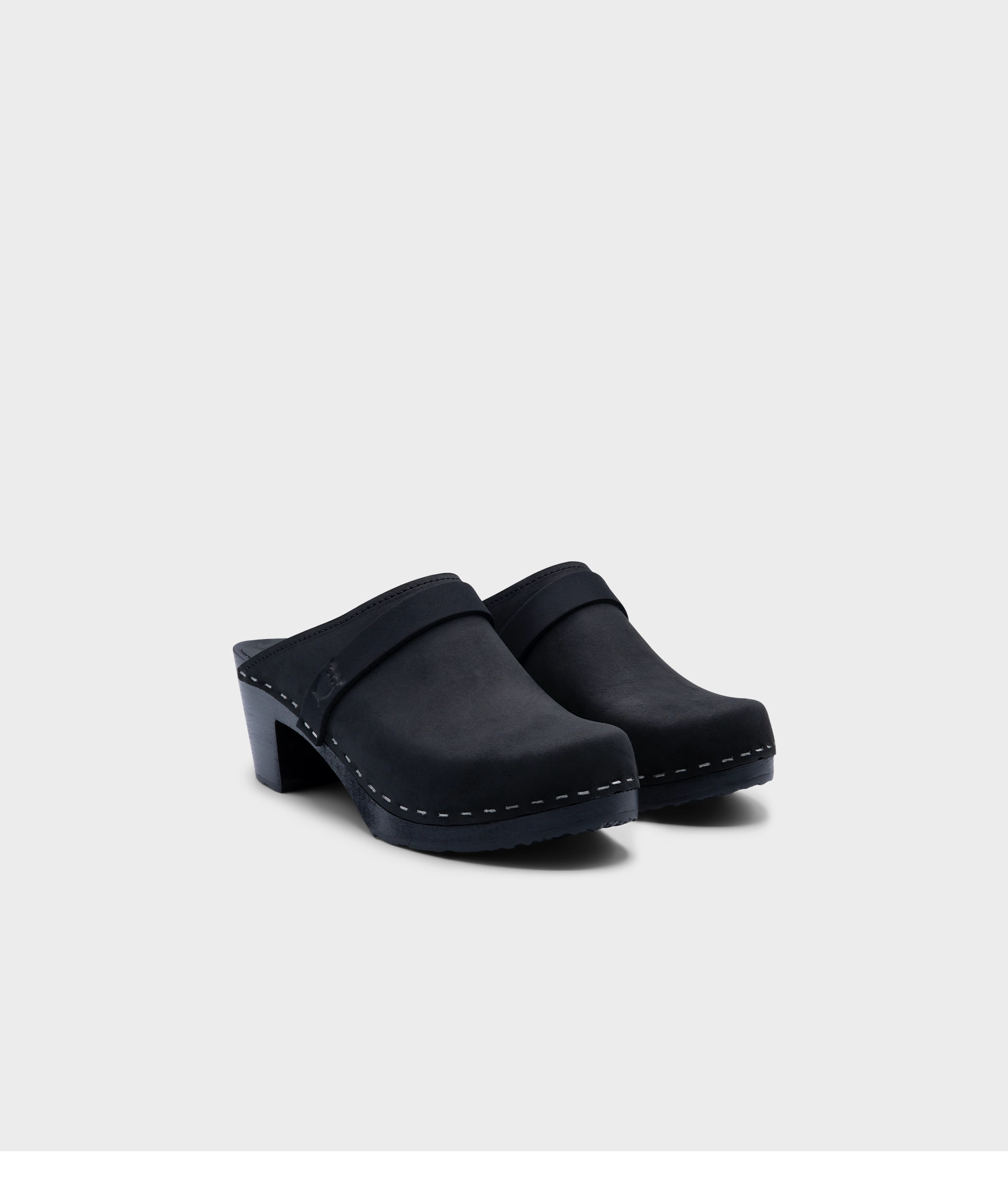 classic high heeled clog mule in black  nubuck leather stapled on a black wooden base with a leather strap